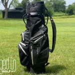 Picture of the BIG MAX Dri Lite Silencio 3 standing vertically in front of a fairway.