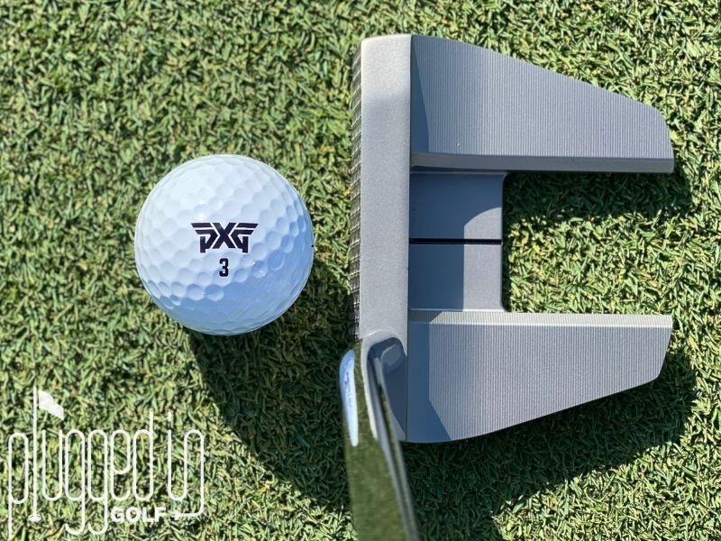Top down picture of The Detroit Putter Co. The Ambassador with a golf ball on a putting green.